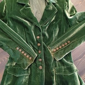 Luxurious emerald green velvet jacket with brass buttons.